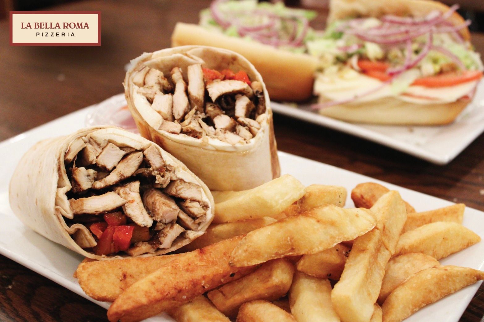 A plate of food with french fries and a wrap on it