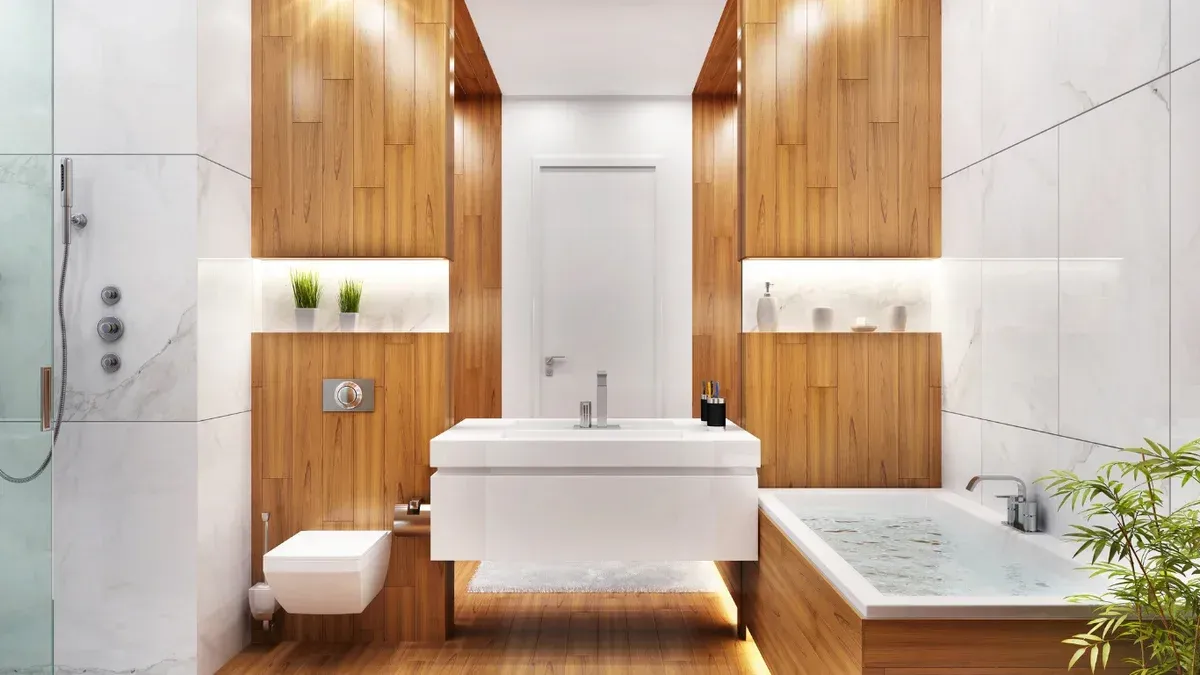 Modern white bathroom with wooden panels, floating vanity, walk-in shower, and a bathtub by a plant.