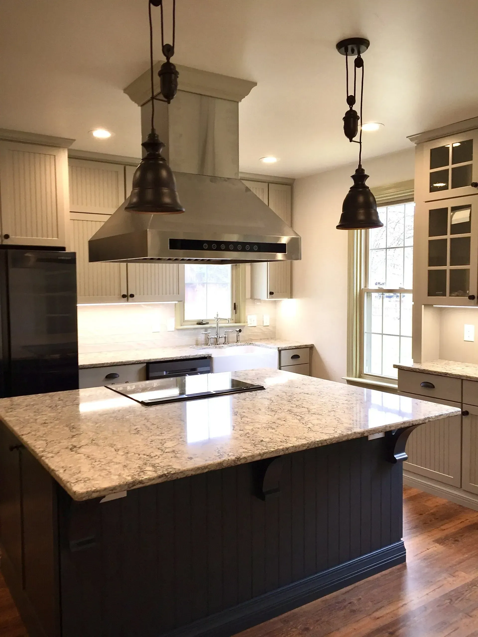 A kitchen with a large island and stainless steel appliances