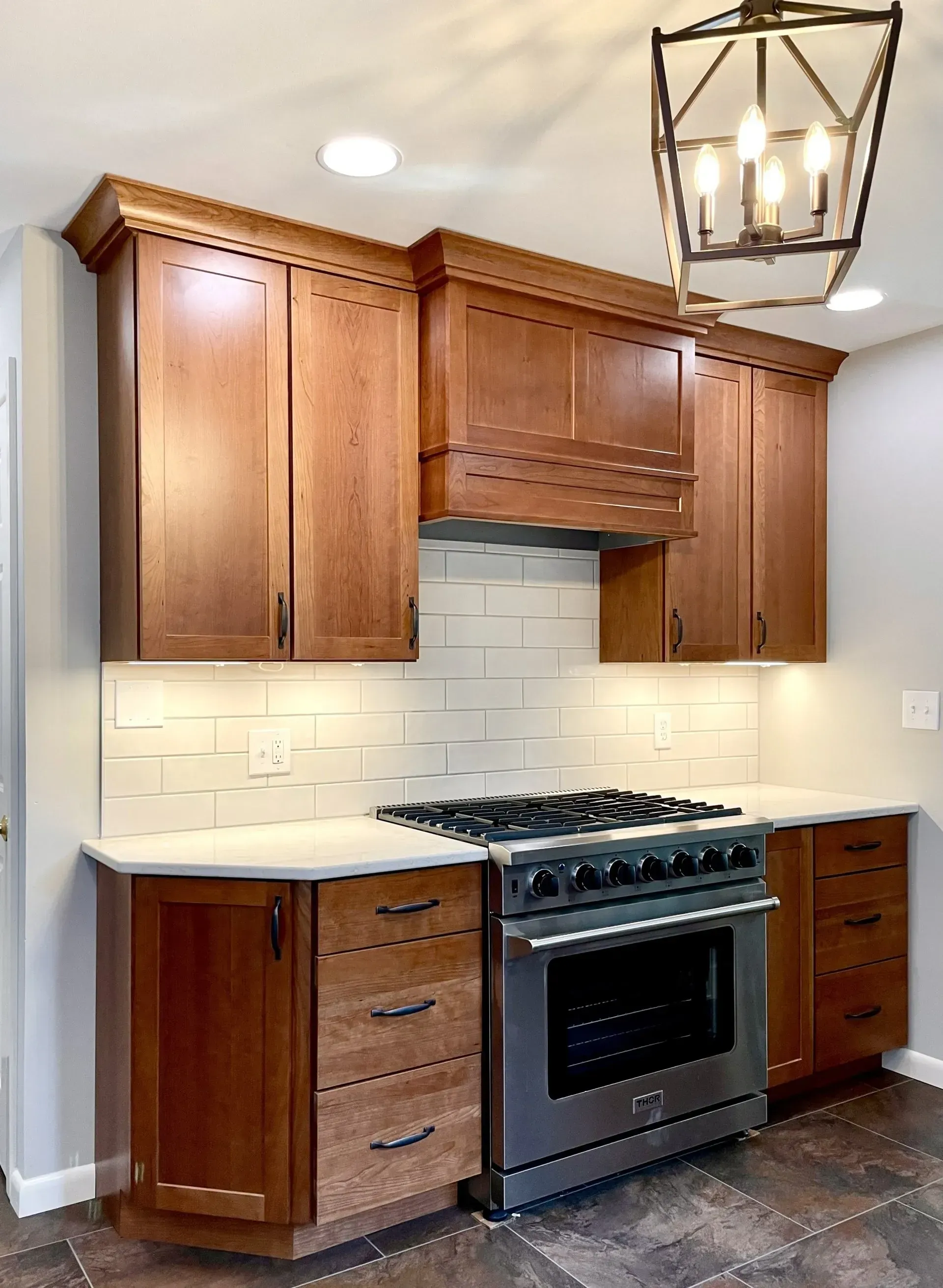 A kitchen with stainless steel appliances and wooden cabinets.