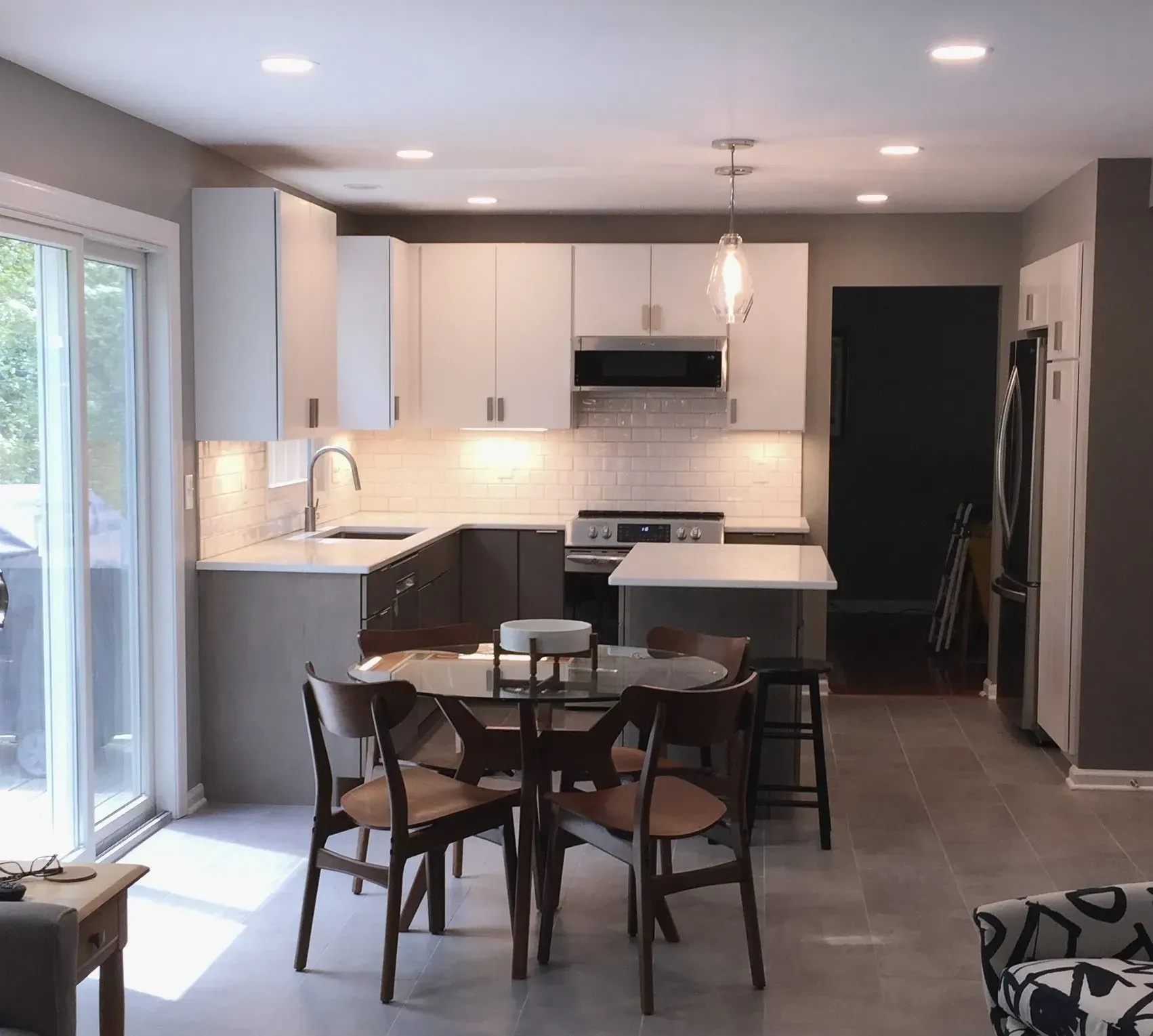 A kitchen with a table and chairs in it