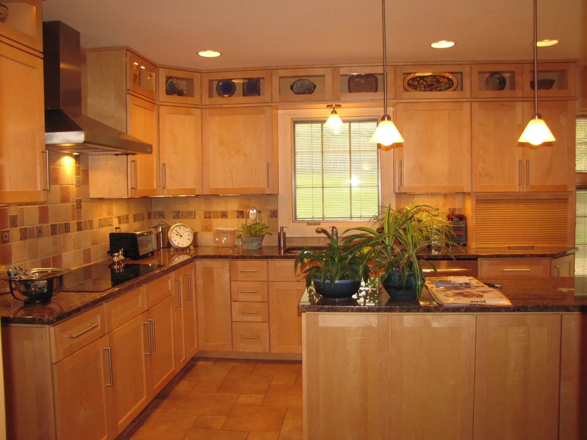 A kitchen with wooden cabinets and granite counter tops