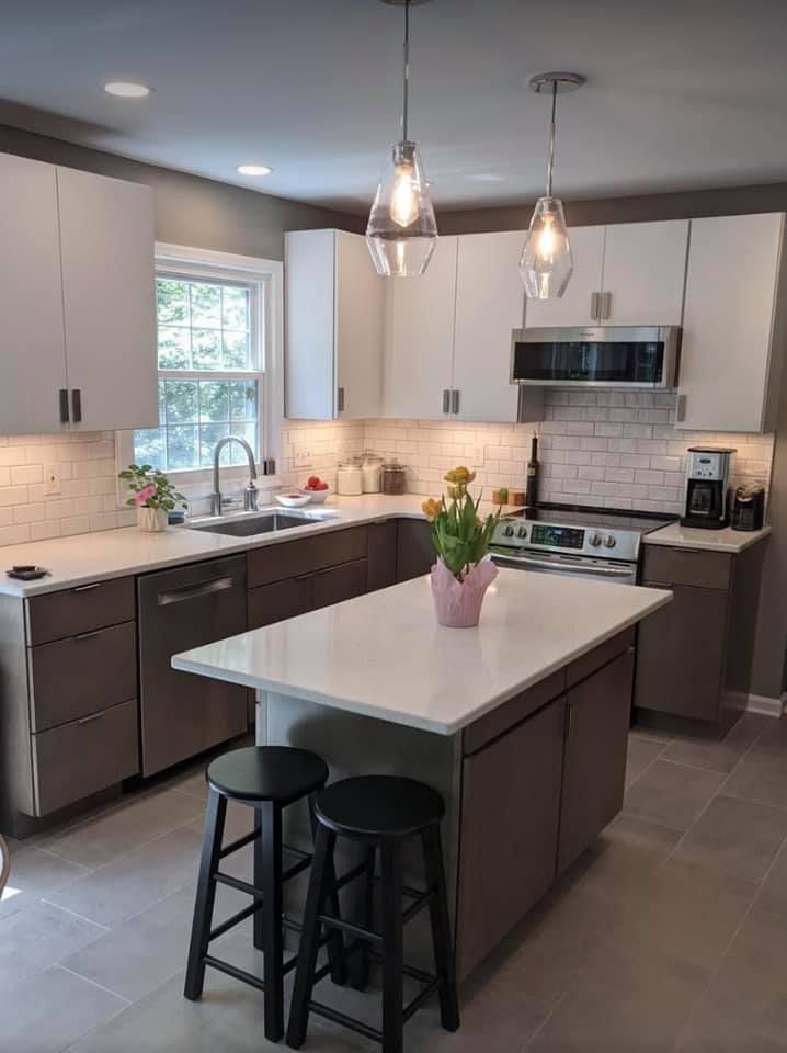 A kitchen with a large island in the middle of it.