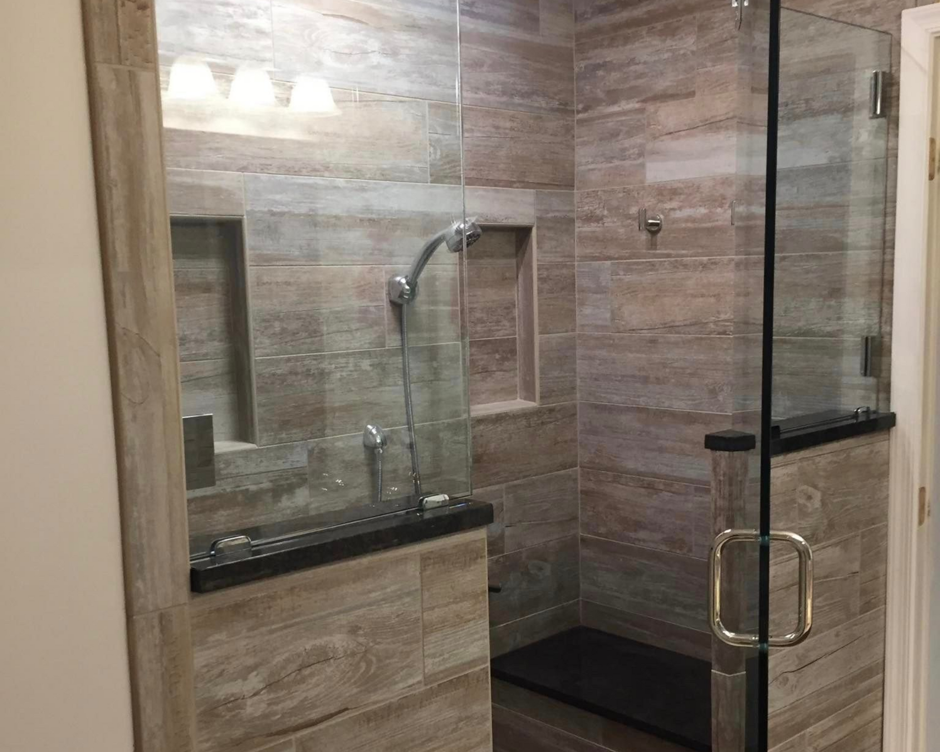 A bathroom with two sinks , a tub , and a walk in shower.