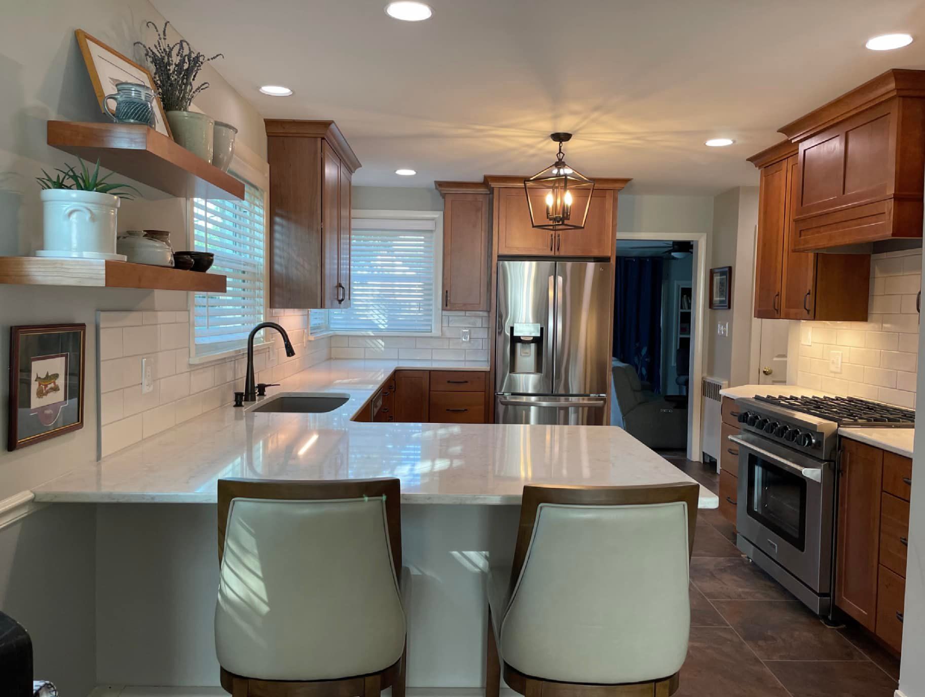 A kitchen with stainless steel appliances and wooden cabinets.