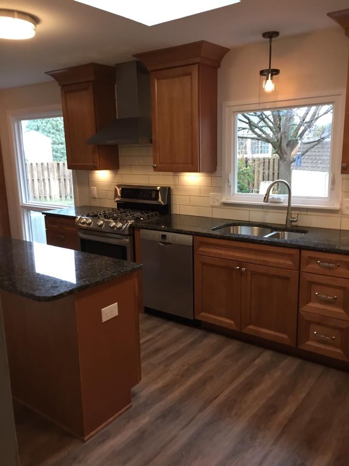 A kitchen with stainless steel appliances and wooden cabinets