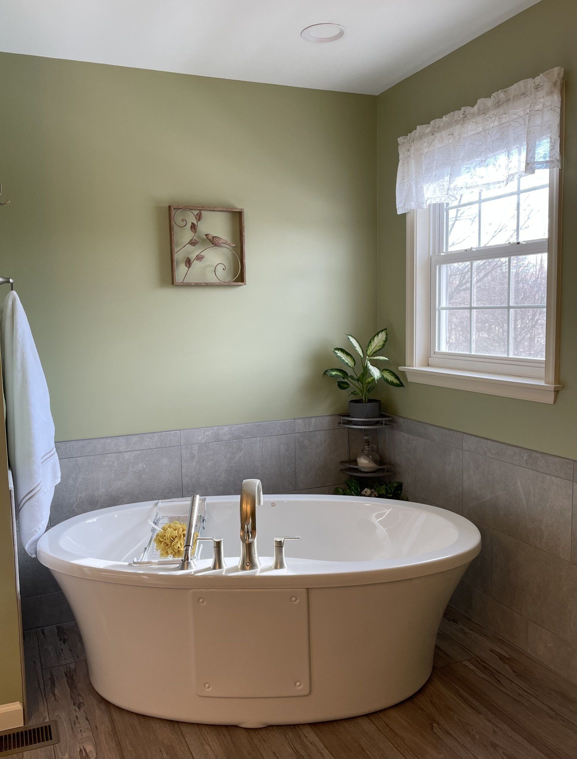 A bathroom with a large tub and a window.