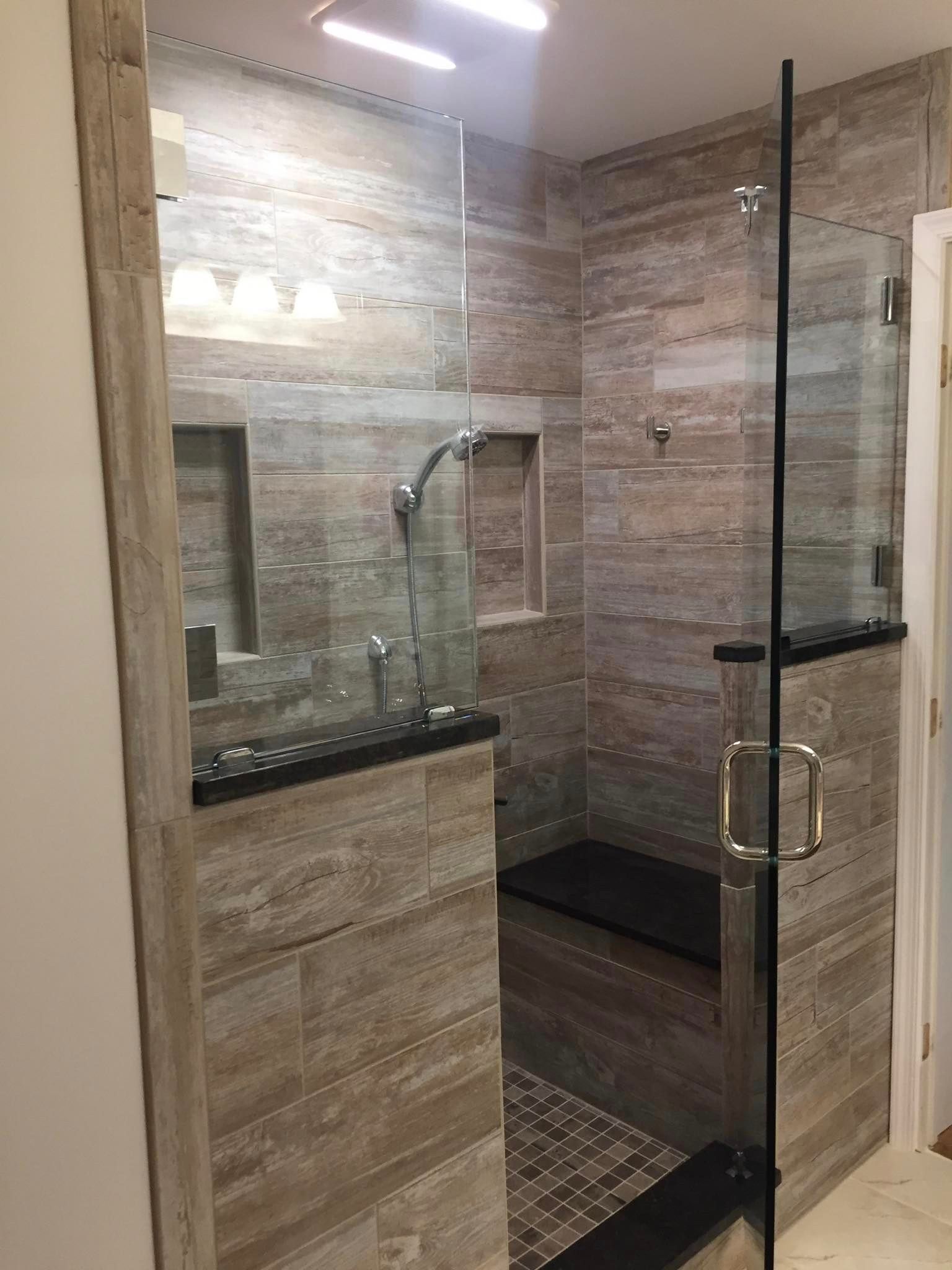 A bathroom with a walk in shower and a sink.