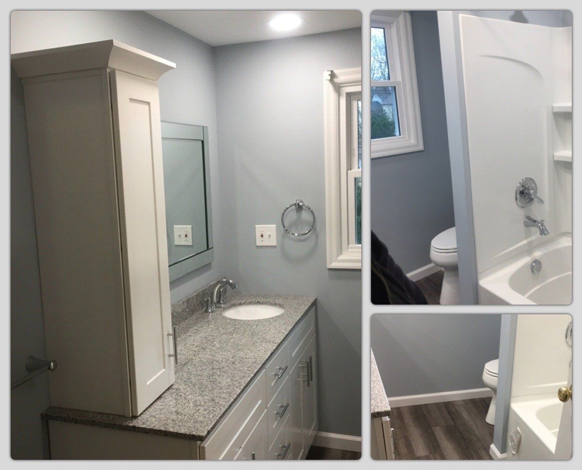 A bathroom with a sink , toilet , mirror and cabinet.