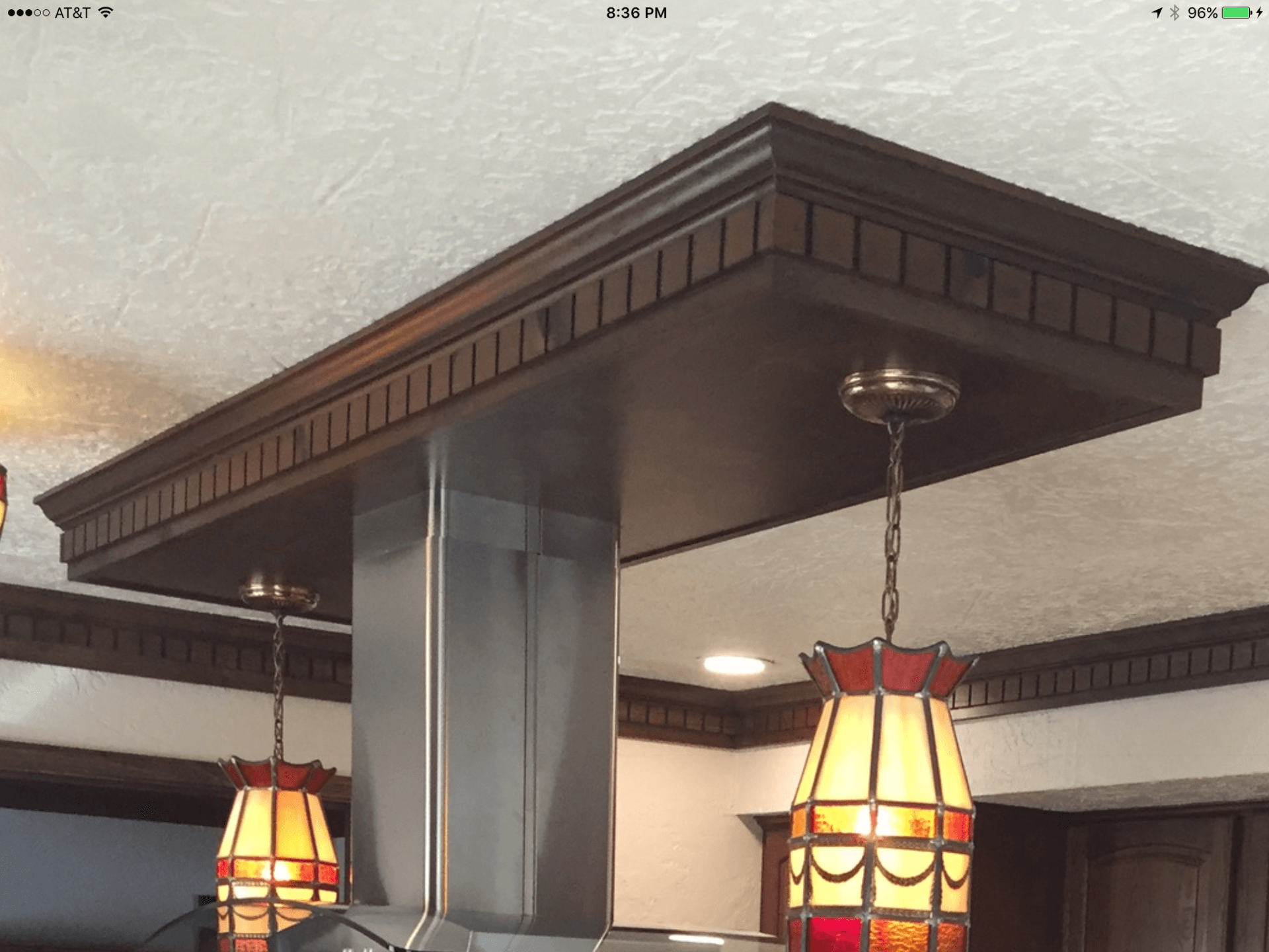 A kitchen with a stained glass lamp hanging from the ceiling