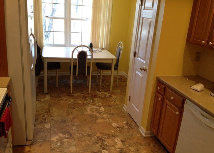 A kitchen with a table and chairs and a window.