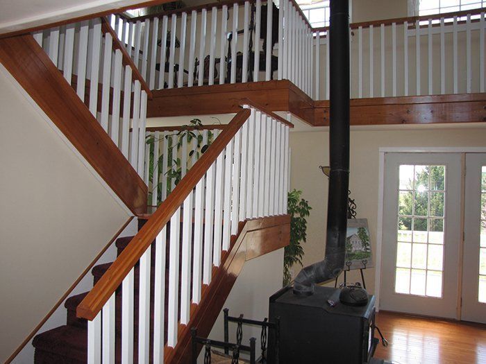 A wooden staircase with white railings in a house