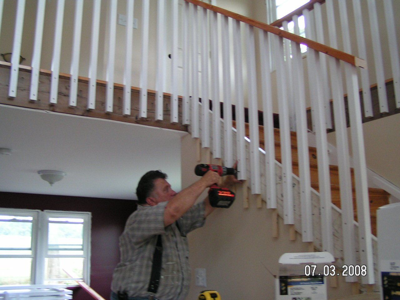 A man is working on a railing on a staircase on 07.03.2008