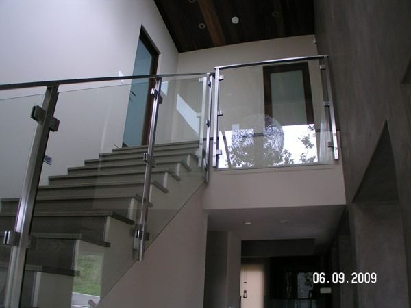 Modern staircase with glass railings in a bright interior hallway