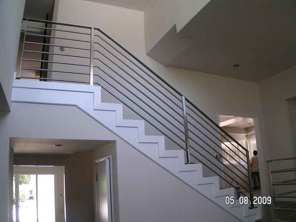 Modern indoor staircase with metal railings in a bright home interior