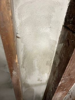 A close up of a wall with wooden beams.