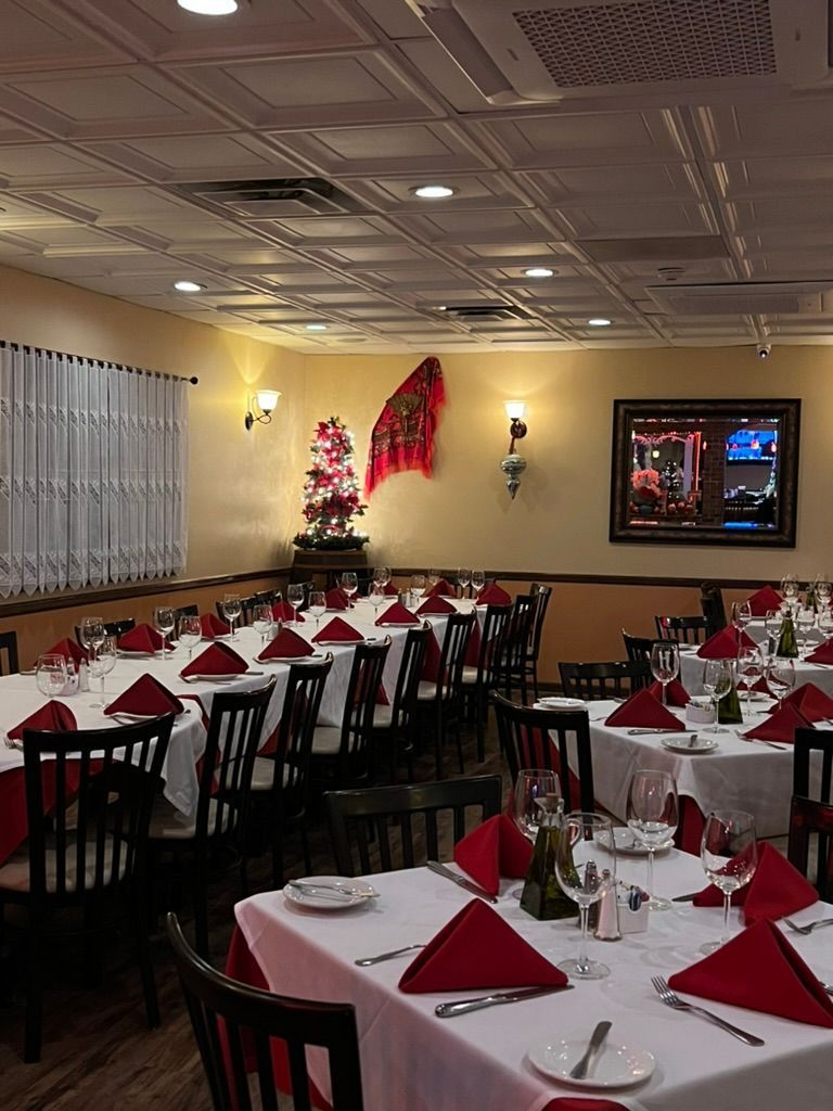 A large dining room with tables and chairs set for a party