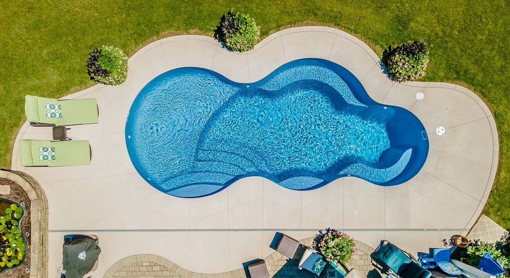 An aerial view of a large swimming pool in a backyard.