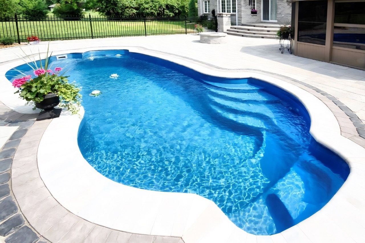 A large blue swimming pool with stairs leading to it