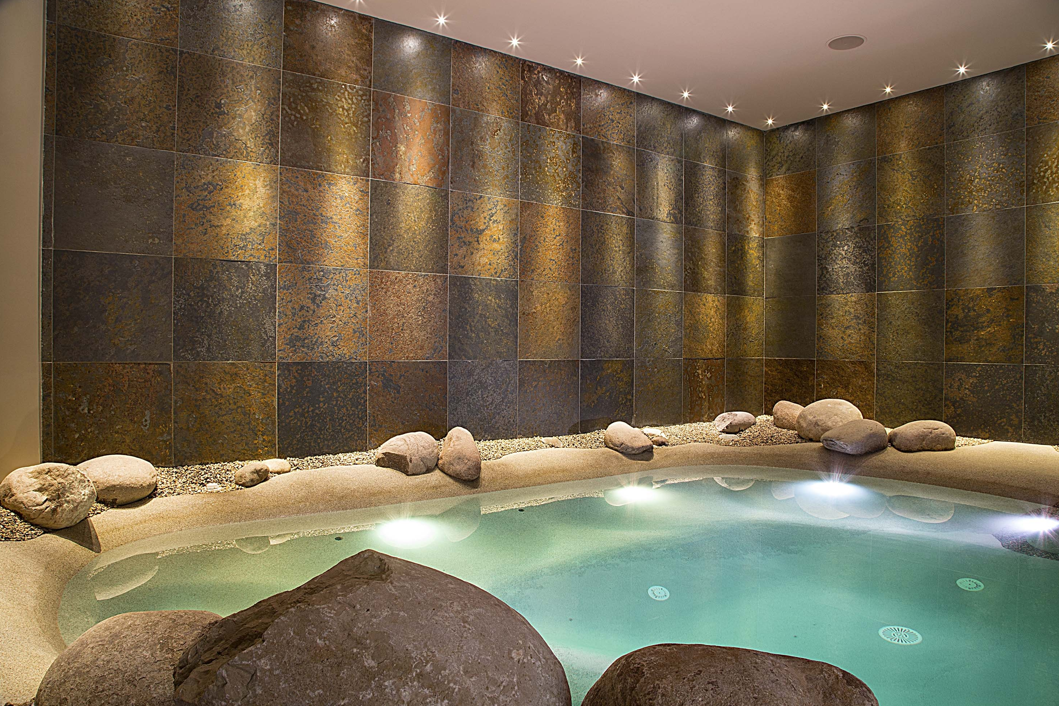 A large swimming pool surrounded by rocks in a spa.