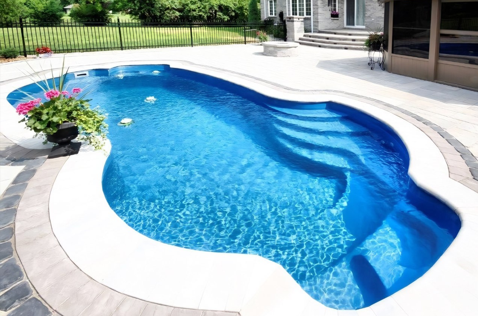 A large blue swimming pool with stairs leading to it