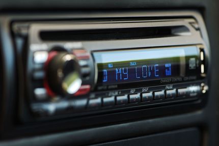 Car stereo dashboard with blue digital display showing “MY LOVE”