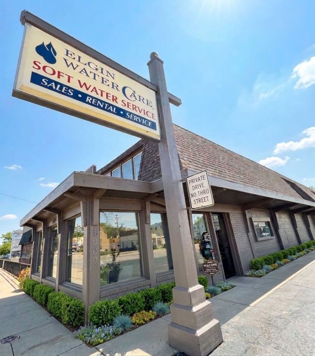 West Star Scott Walker sign outside a tan brick commercial building on a sunny day