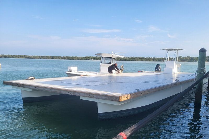 A boat is docked at a dock in the water.