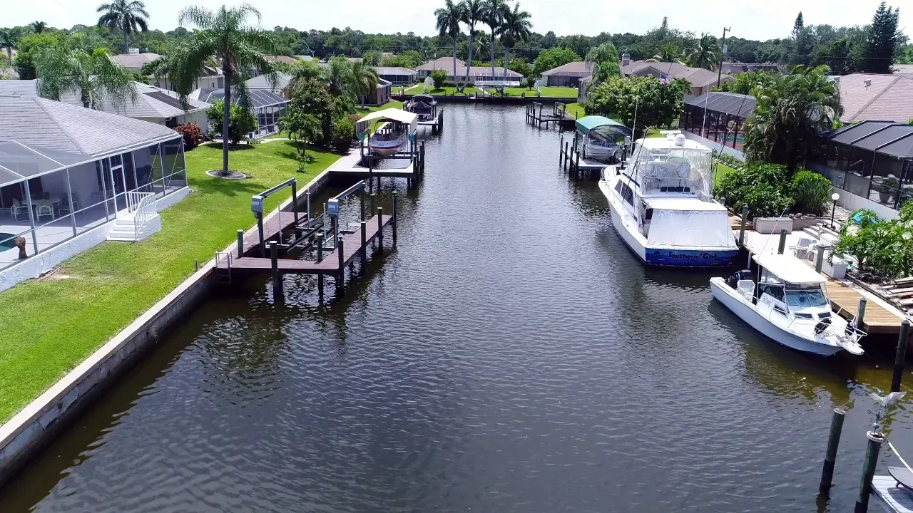 An aerial view of a canal with boats docked in it