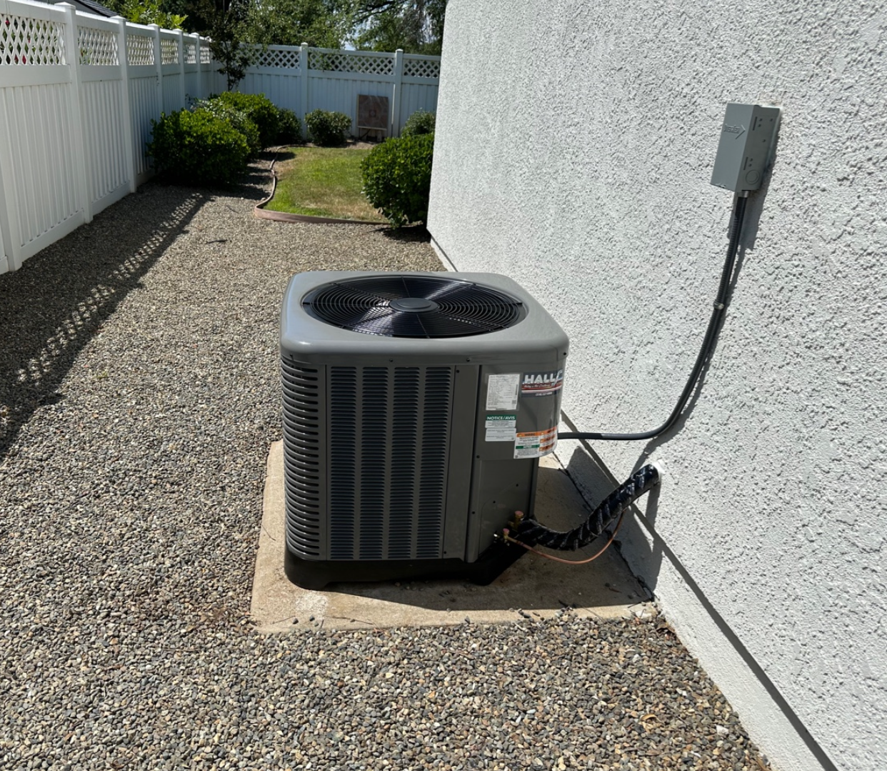 An air conditioner is sitting on the side of a house