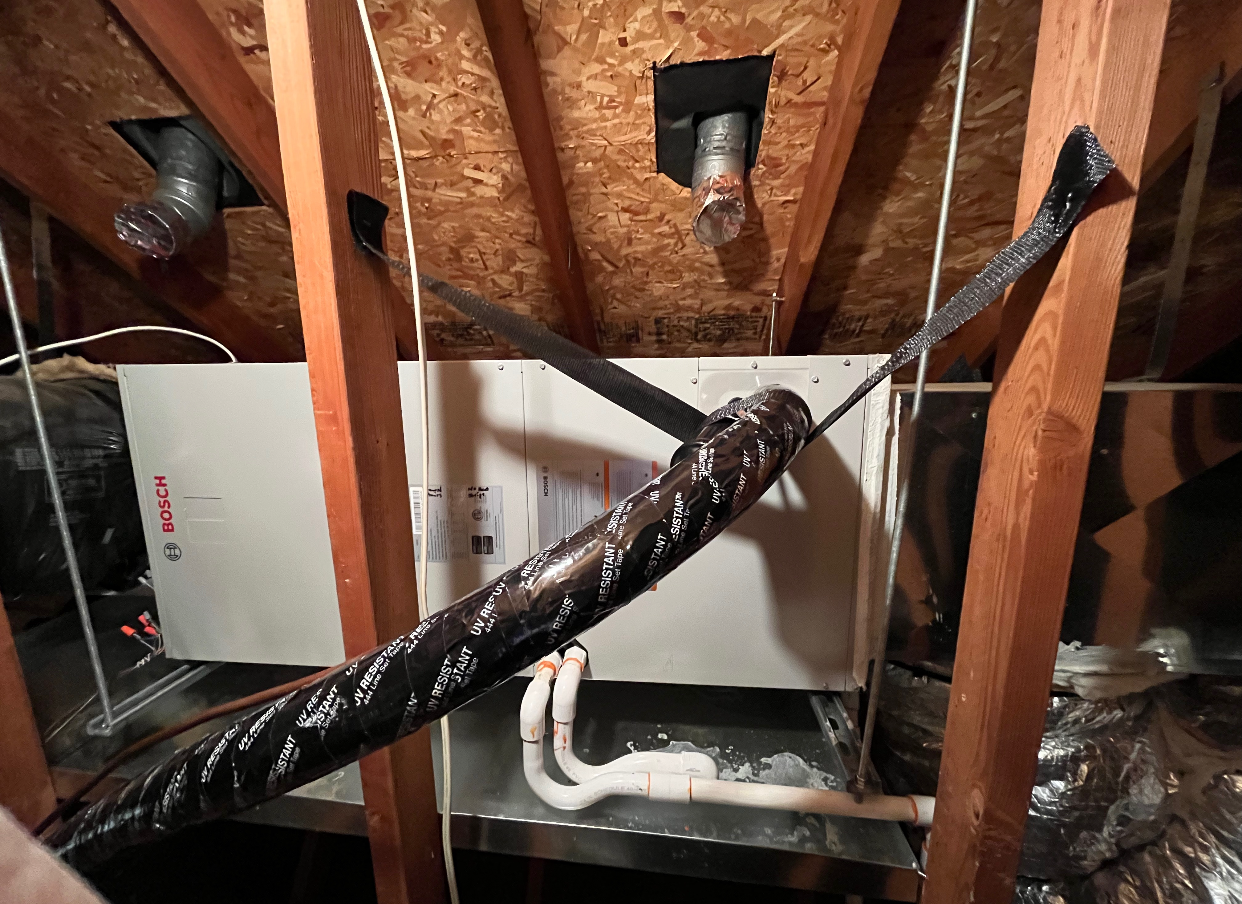 A hose is hanging from the ceiling of a house