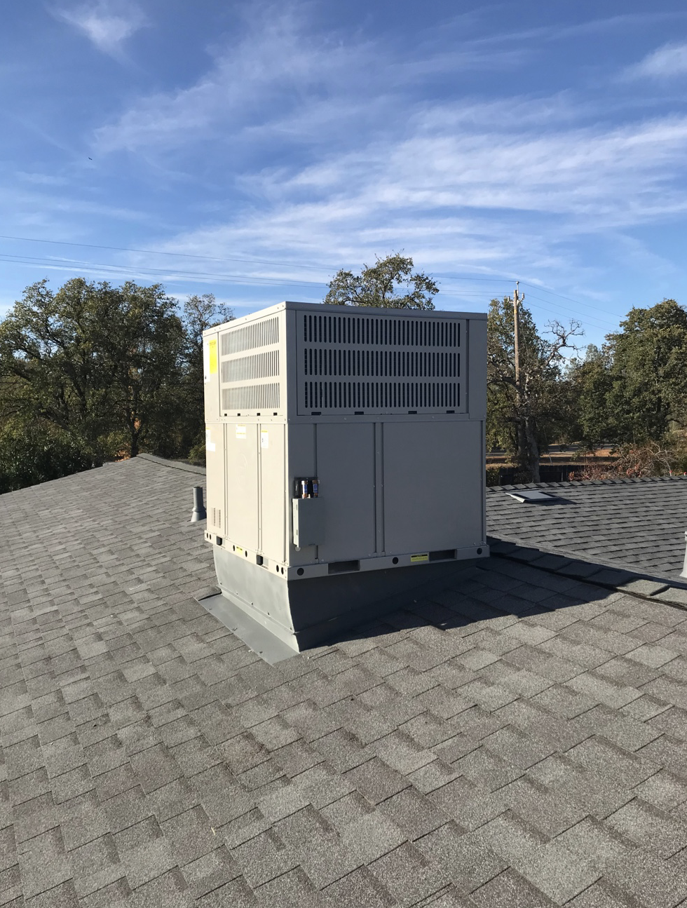 A large white box is sitting on top of a roof