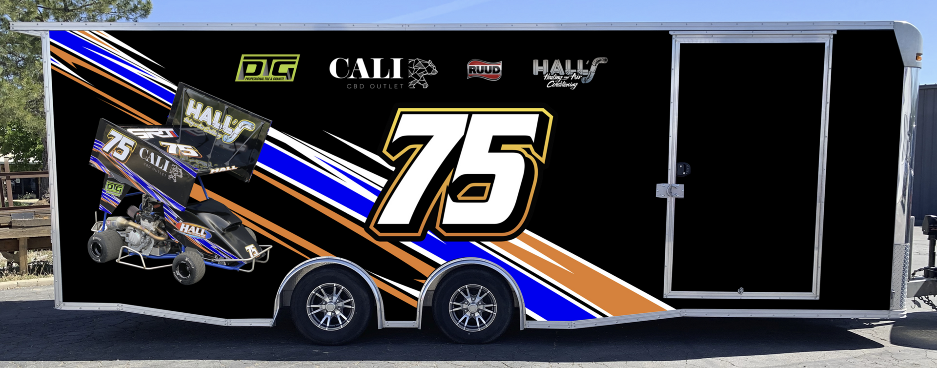 A black trailer with the number 75 on it