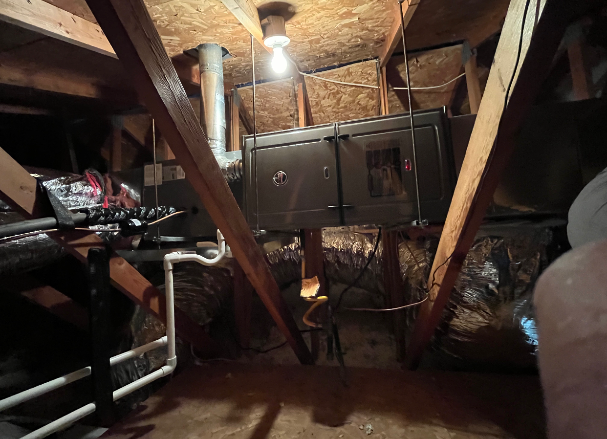 A room with a lot of pipes and a light on the ceiling