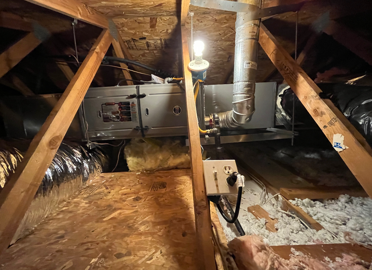 A picture of an attic with a light on