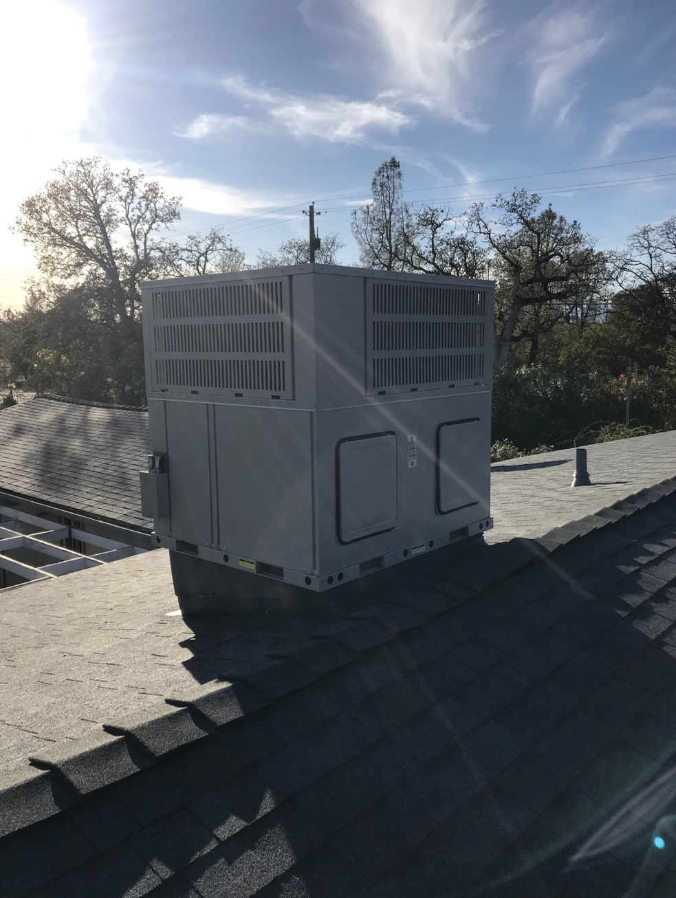 A white box is sitting on top of a roof