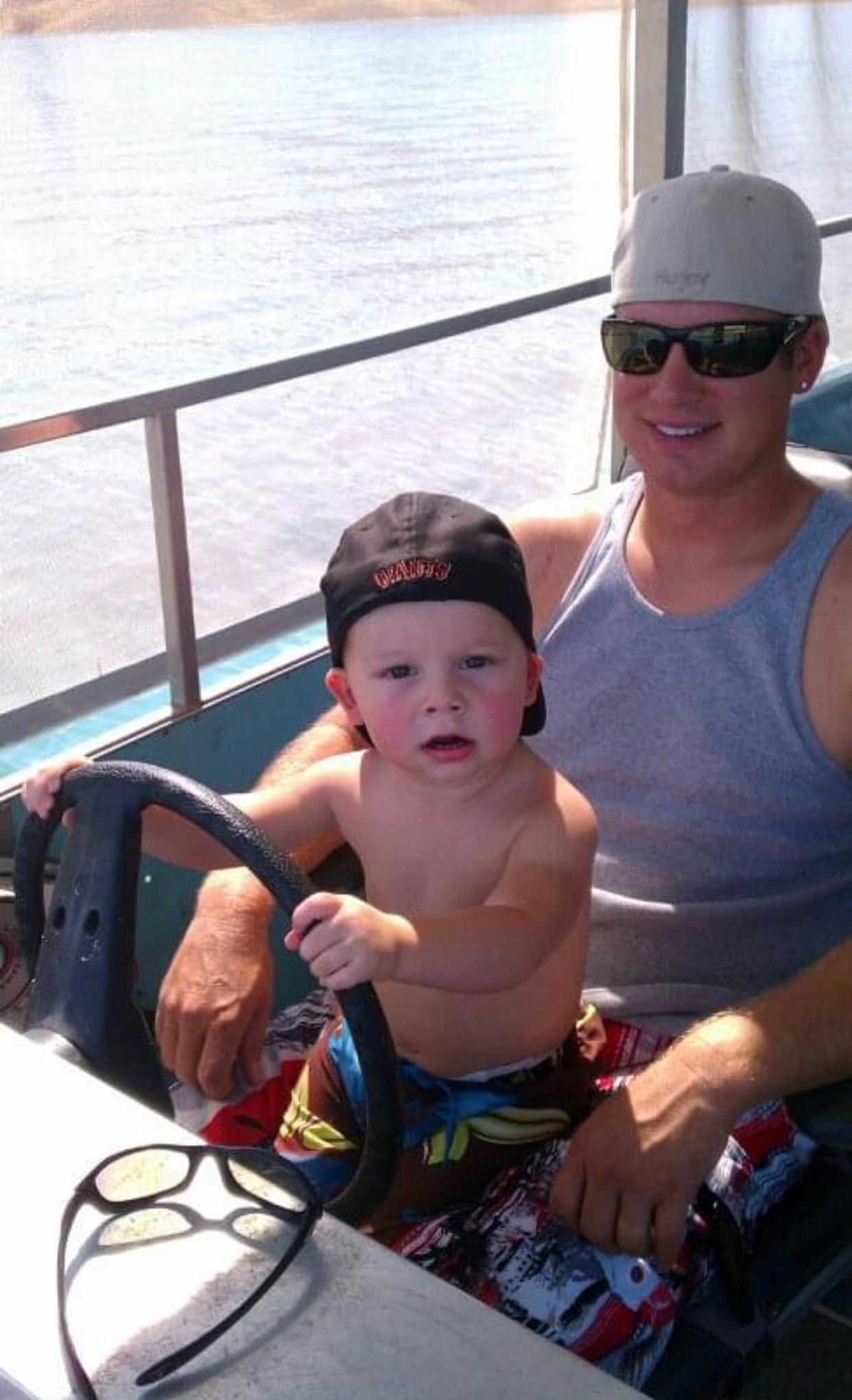 A man and a baby are sitting on a boat