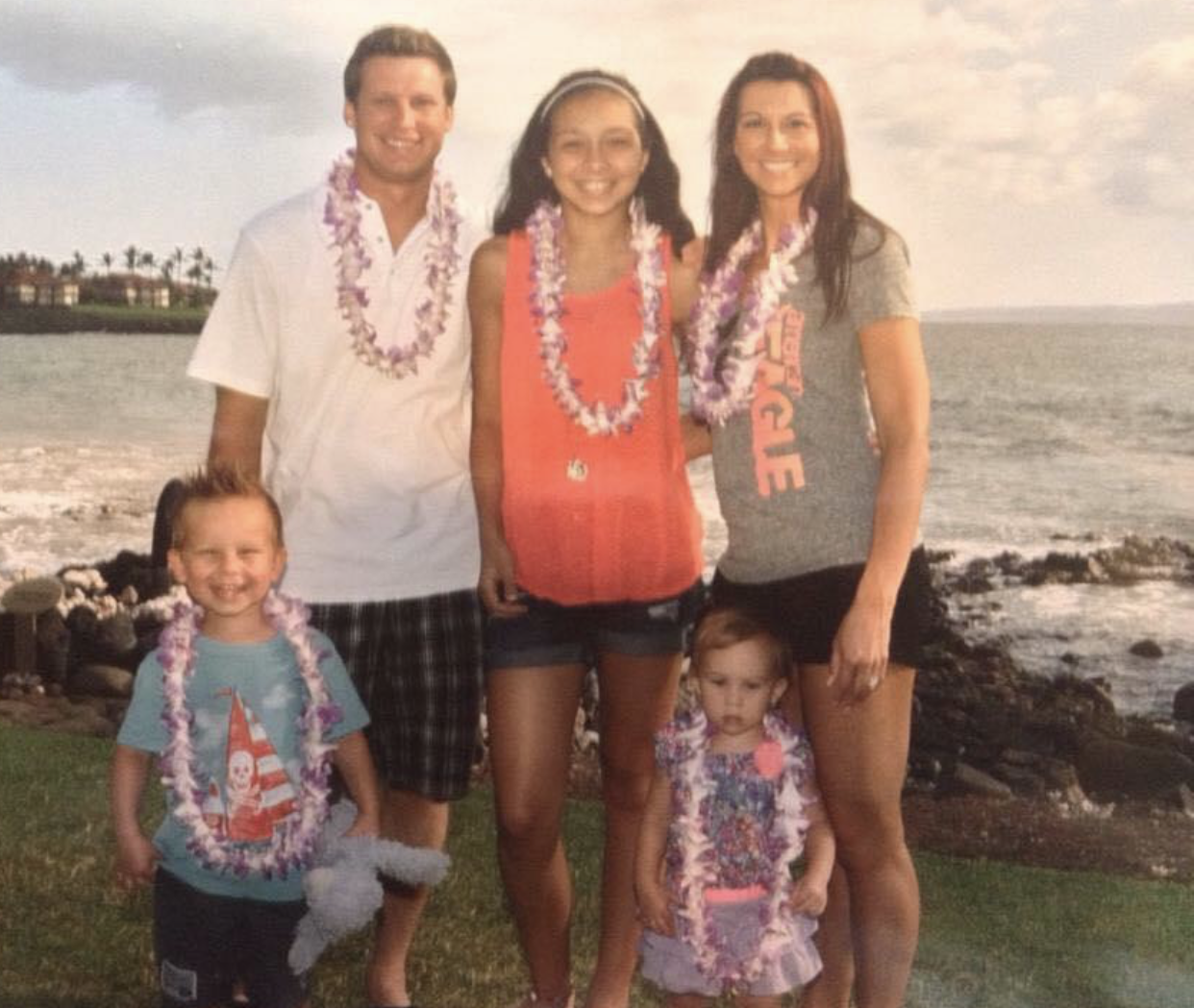 A group of people posing for a picture with one wearing a shirt that says eagle