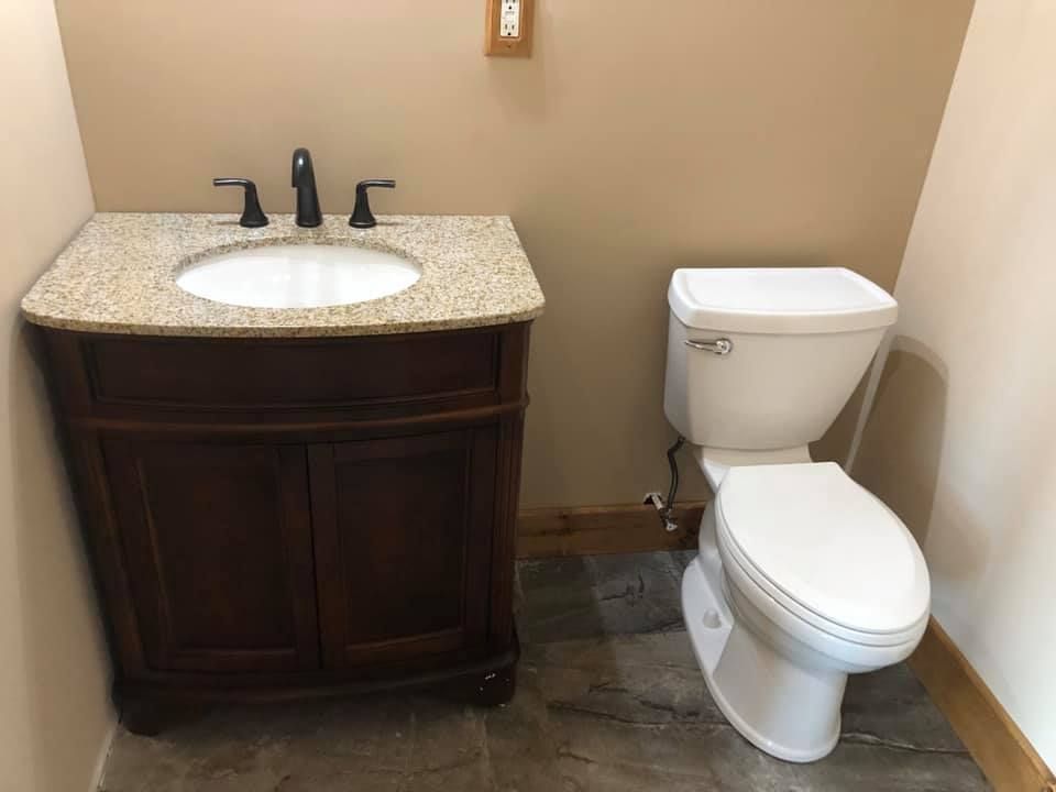 A bathroom with a sink and toilet in it.