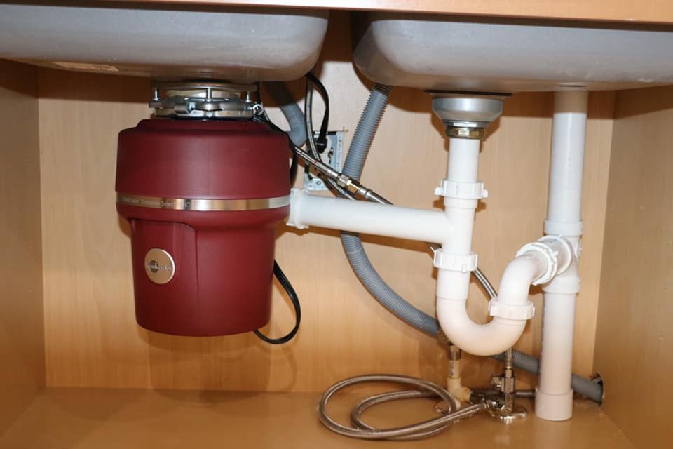 A sink with a garbage disposal underneath it