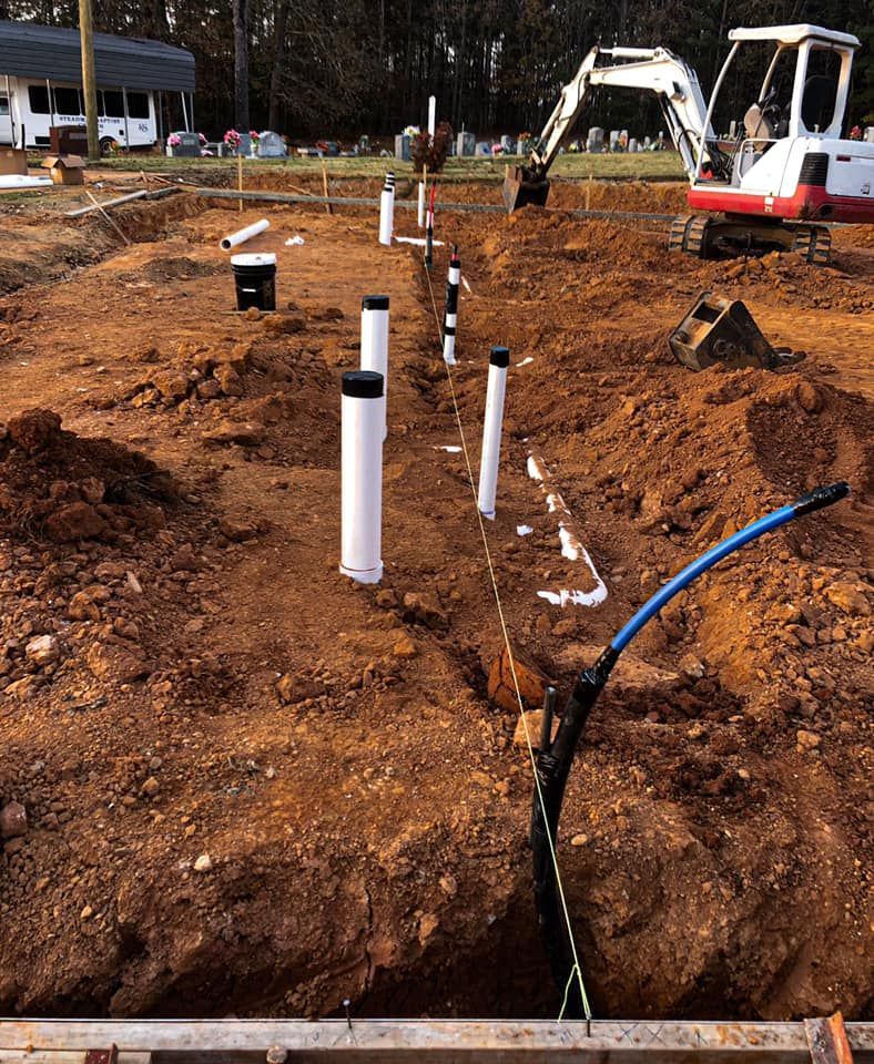 A construction site with a red excavator in the background