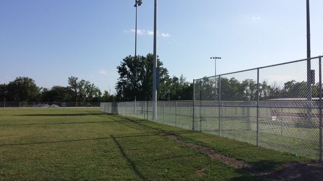 A baseball field with a chain link fence surrounding it.