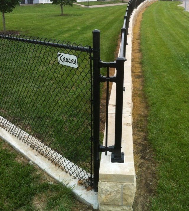 A chain link fence with the word kansas on it