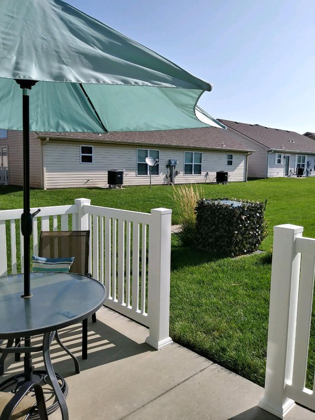 A patio with a table and chairs under an umbrella