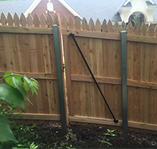 A wooden fence with a metal pole attached to it.