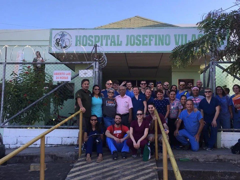 Staff in front of a hospital