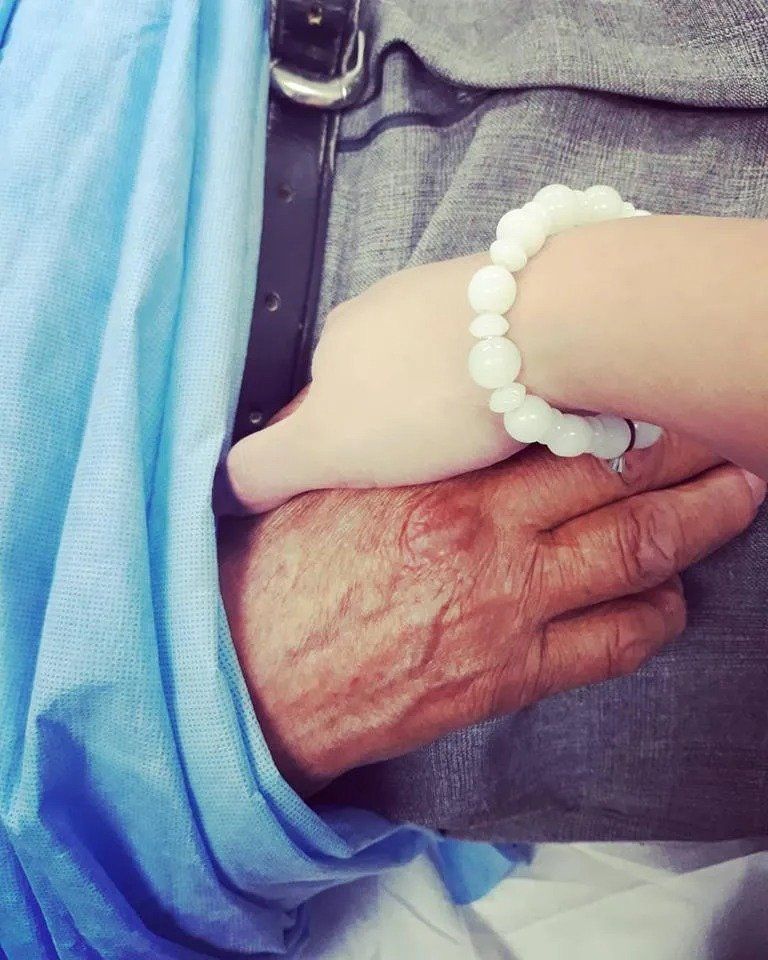 Staff holding hand with a patient