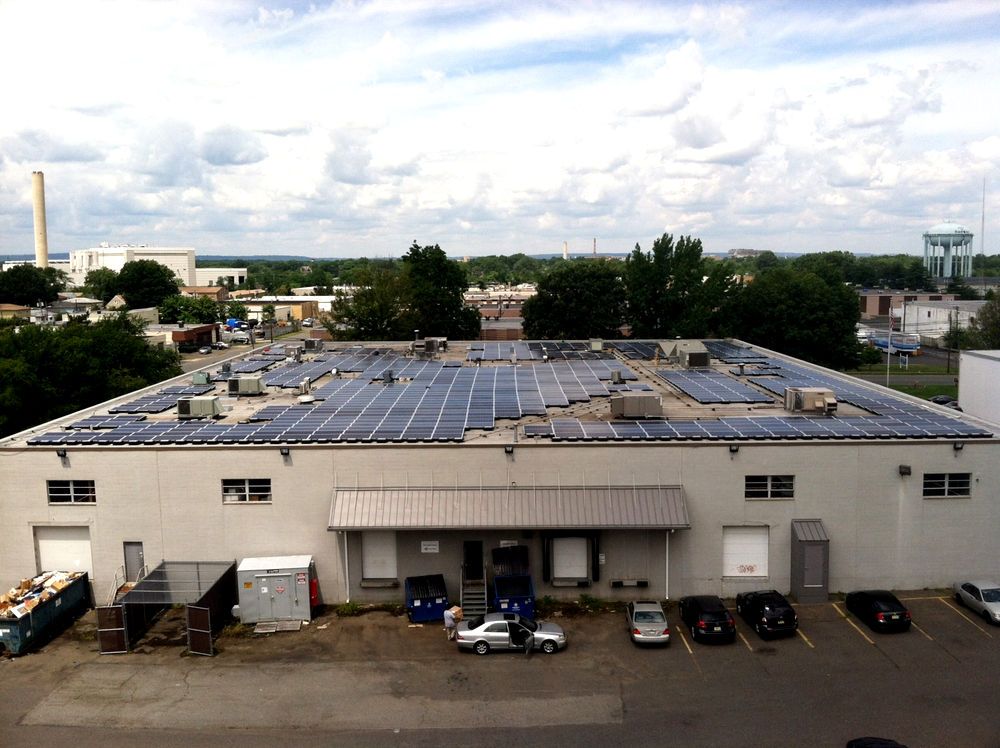 A large building with a lot of solar panels on the roof.