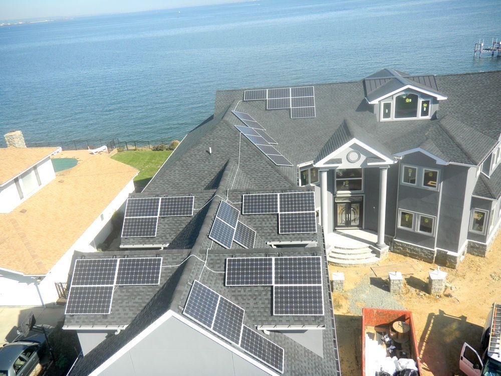 A large house with a lot of solar panels on the roof.