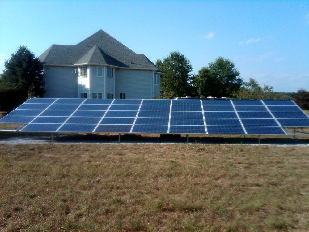 A house with a lot of solar panels in front of it.